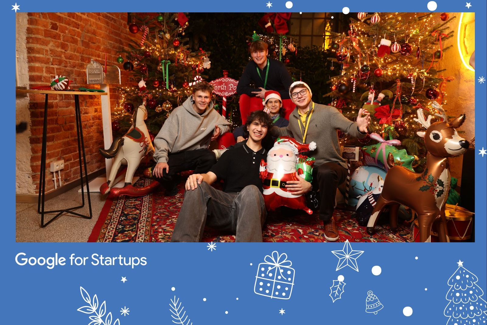 The Codaro team posing in front of Christmas trees at a Google for Startups party, Mikita holding an inflatable Santa.