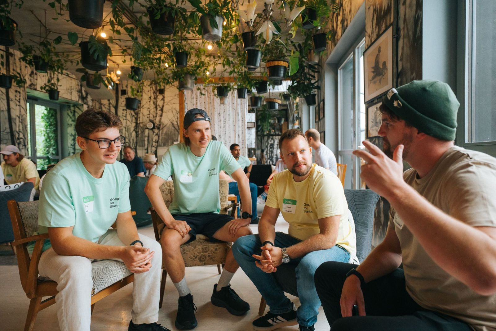 Mikita in a Google for Startups T-shirt in conversation with three other founders.